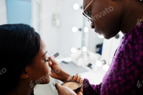 Preview: African American woman applying make-up