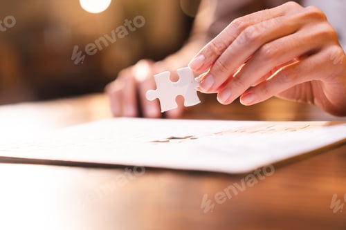 Preview: Business person team work holding jigsaw to connecting successful puzzle piece