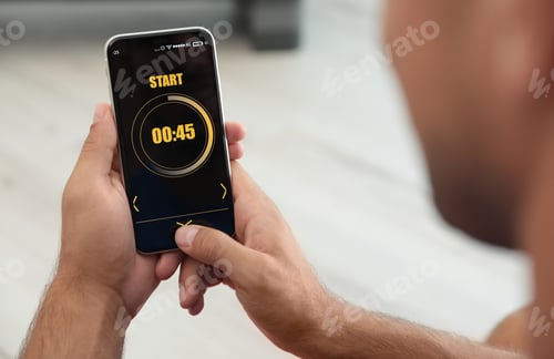 Preview: Man using fitness app on smartphone indoors, closeup