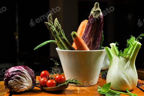 Preview: rustic composition of vegetables on wooden table and cutting board with black background