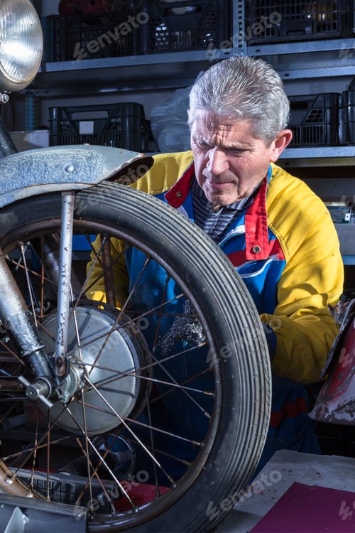 Preview: Mechanic sanding the motorcycle wheel spokes
