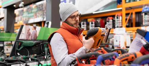 Preview: buyer in a store for a choice of power tools for domestic household needs