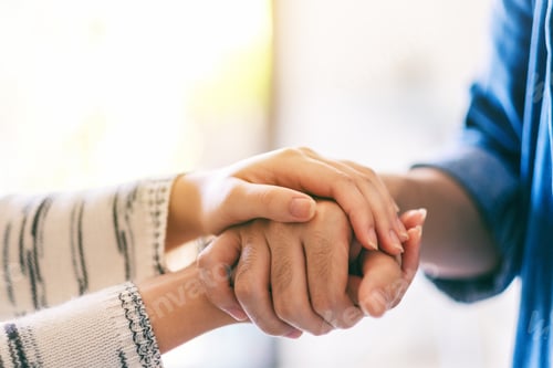 Preview: A man and a woman holding each other hands for comfort and sympathy