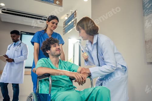 Preview: Caucasian doctor support patient sit on wheelchair in hospital hallway.