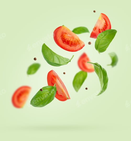 Preview: Flying ingredients of tomatoes, basil, black pepper on green background. Italian food