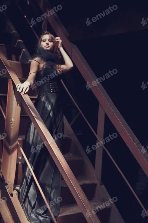Preview: blonde girl in black dress at an old abandoned factory. steampunk