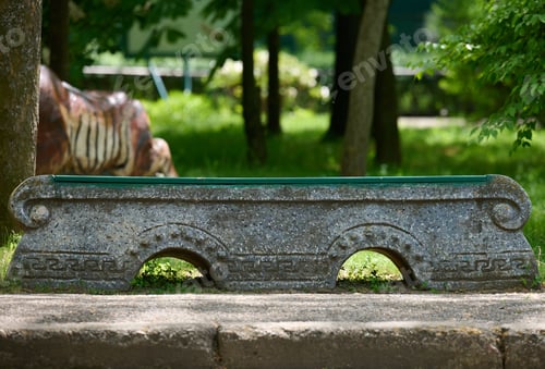 Preview: Empty stone bench in the city garden