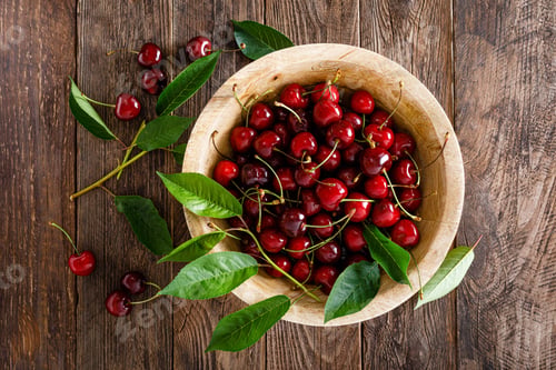 Preview: Sweet cherry with leaves in wooden bowl. Fresh ripe cherries. Cherry fruit
