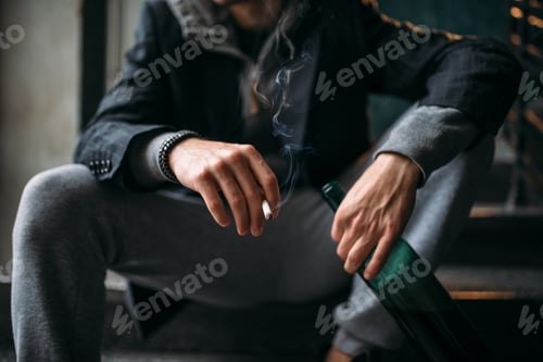 Preview: Guy with bottle sits on the stairs and smoking