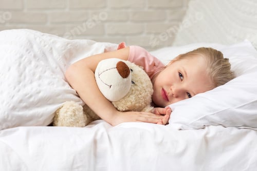 Preview: Cute little child girl sleeping with teddy bear