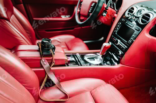 Preview: Red luxury car interior - dashboard with gauges, steering wheel and shift lever. Modern car