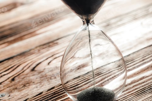 Preview: Modern hourglass on wooden background