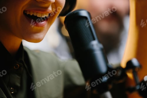 Preview: Close-up, dubbing actor or radio host speaking into a microphone.