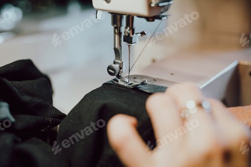 Preview: woman sews on the sewing machine