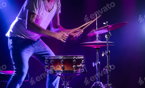Preview: A drummer plays drums on a blue background. Beautiful special effects of light and smoke.