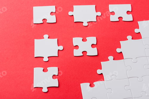 Preview: white connected and separate jigsaw puzzle pieces isolated on red