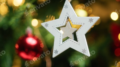 Preview: Star decoration adorning a Christmas tree