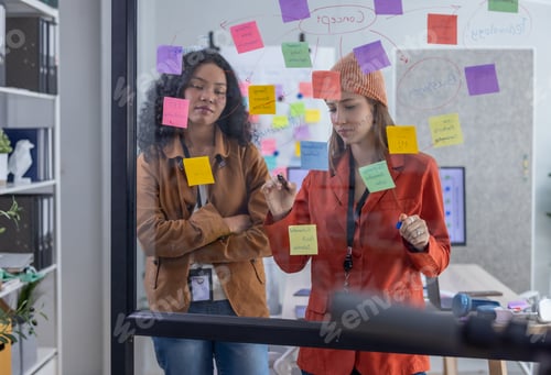 Preview: Multicultural startup team collaborate, brainstorm, exchange ideas using sticky notes for solutions
