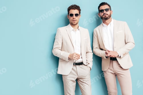 Preview: Two handsome men in suit posing in studio