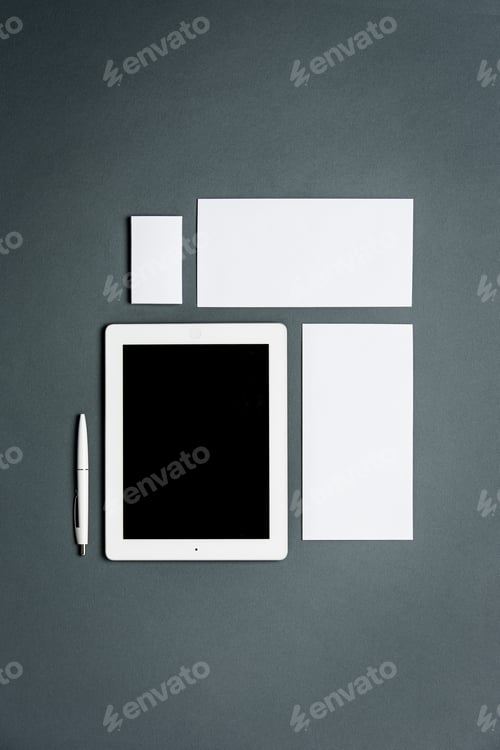 Preview: Mock-up business template with cards, papers, tablet. Gray background.