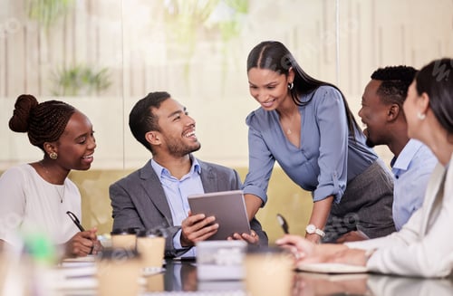 Preview: Shot of a group of coworkers using a digital tablet during a business meeting