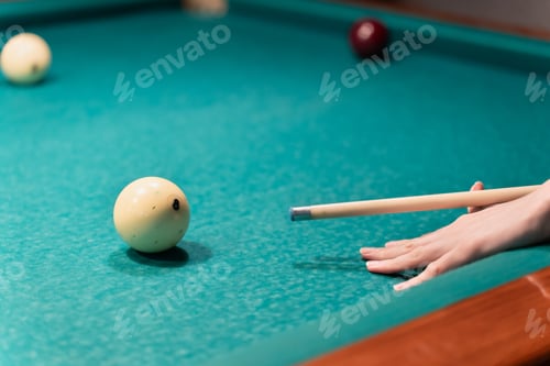 Preview: Focused Hand Preparing A Billiard Shot With The White Ball. Woman playing billiards