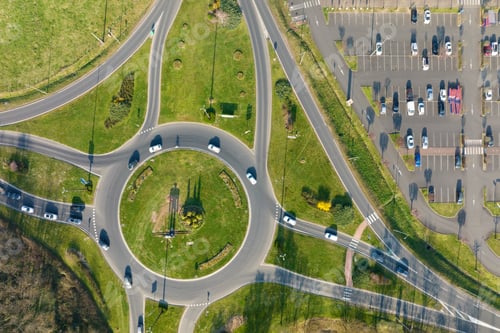 Preview: Aerial view of road roundabout intersection with moving heavy traffic.