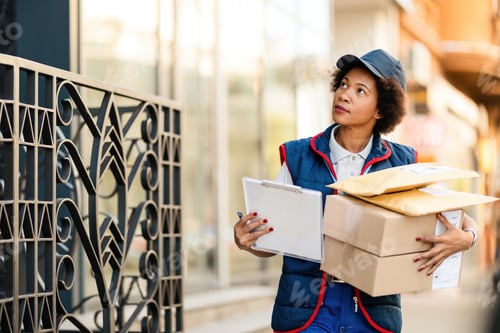 Preview: Black female courier looking for a place to deliver the package in the city.