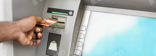 Preview: Close up of man using ATM with gold credit card