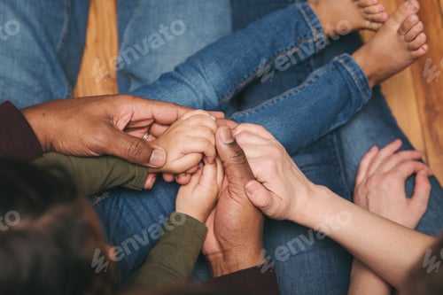 Preview: A multiracial family holding hands in love and support