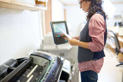 Preview: Woman adjusting settings on printer