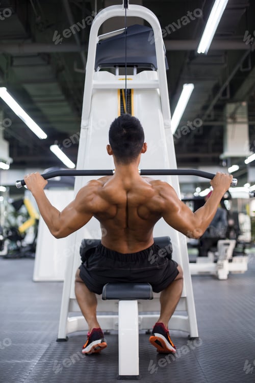 Preview: Young man exercising at gym