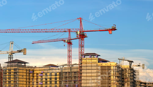 Preview: Tower lifting cranes at high residential apartment buildings construction site.