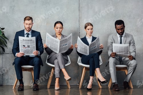 Preview: multiethnic businesspeople sitting on chairs and reading newspapers in waiting hall