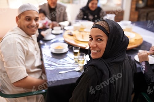 Preview: Portrait of a muslim woman looking back while enjoying a feast with her family