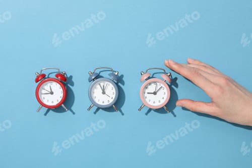 Preview: Classic multicolored alarm clocks with on a blue background