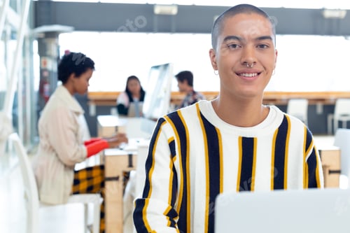 Preview: Young Mixed-race Businessman working on desk in the modern office while colleagues working