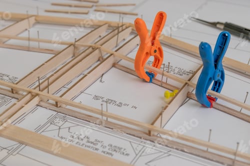 Preview: High angle shot of construction of plane model aircraft on a white paper