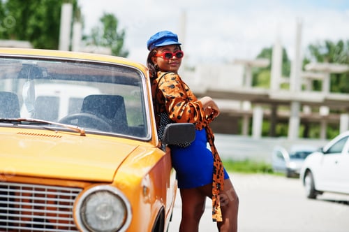Preview: African american lady near orange classic retro car