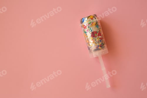 Preview: Multicolored candy in a package on a pink background. Candy is the best decor for your merry holiday
