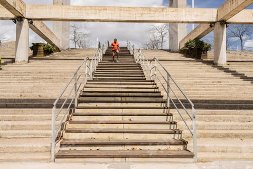 Preview: Mature african american man doing a cardio exercise going down and up stairs outdoors