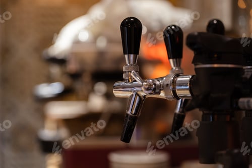 Preview: Drinks and beverages concept . Beer taps on blurred background