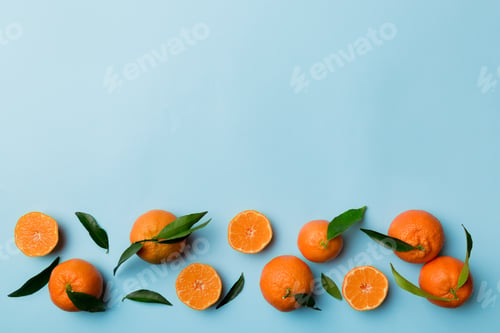 Preview: Many fresh ripe mandarin with green leaves on colored background, top view, space for text