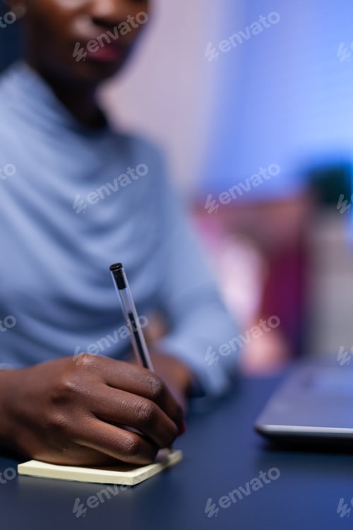 Preview: Close up of african woman taking notes
