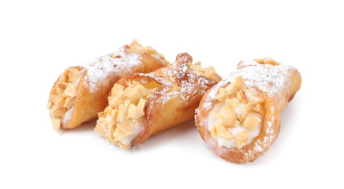 Preview: Delicious cannoli with ricotta cheese, peanuts and powdered sugar isolated on white