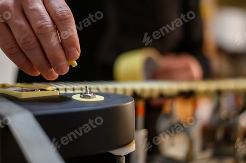 Preview: Guitar in repair service shop with a hands of a guitar luthier which fixes it