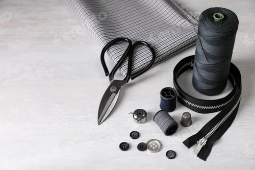 Preview: Set of sewing supplies and accessories on white table, space for text
