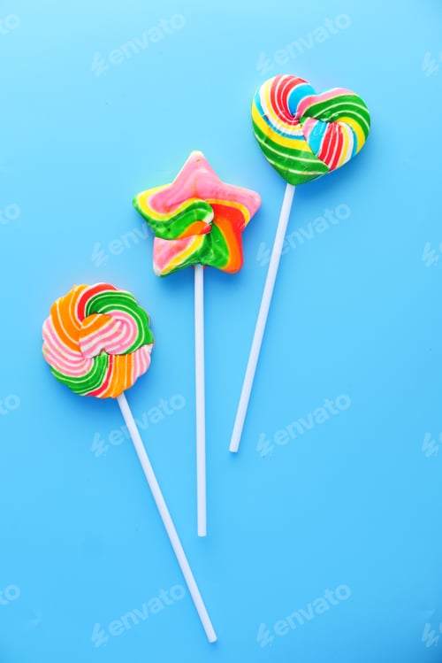 Preview: Top view of colorful lollipop on blue background,