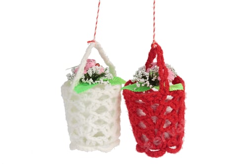 Preview: Two flower pots in a knitted cover. It is located on a white background. Close-up.