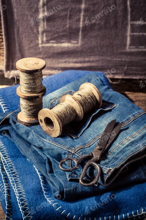 Preview: Closeup of cloth, needle and scissors in tailor workshop